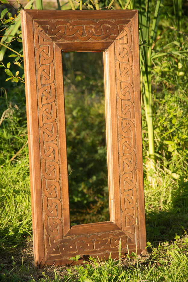 Carved and stained Celtic lime mirror.